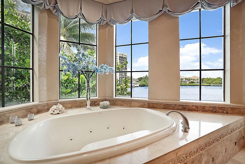 This dream home features a home office, theater, chef's kitchen with high-end appliances, dual-zone wine refrigerators, and lavish architectural details.