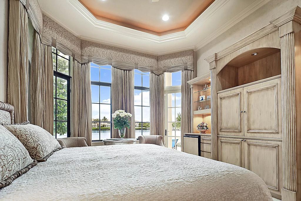 This dream home features a home office, theater, chef's kitchen with high-end appliances, dual-zone wine refrigerators, and lavish architectural details.