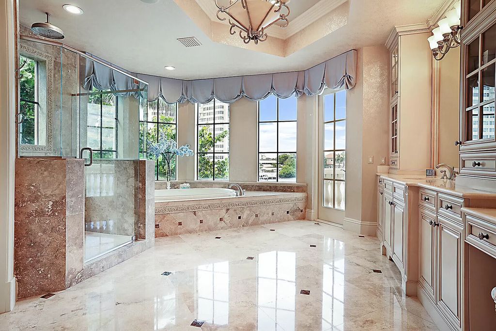 This dream home features a home office, theater, chef's kitchen with high-end appliances, dual-zone wine refrigerators, and lavish architectural details.