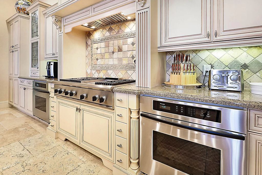 This dream home features a home office, theater, chef's kitchen with high-end appliances, dual-zone wine refrigerators, and lavish architectural details.