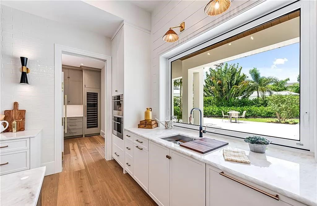 Experience luxury in this modern farmhouse at 712 Killdeer Pl, Naples, Florida. Built by the award-winning Van Emmerik Custom Homes, this 6,500 square feet home features high ceilings, beautiful millwork, and premium finishes.