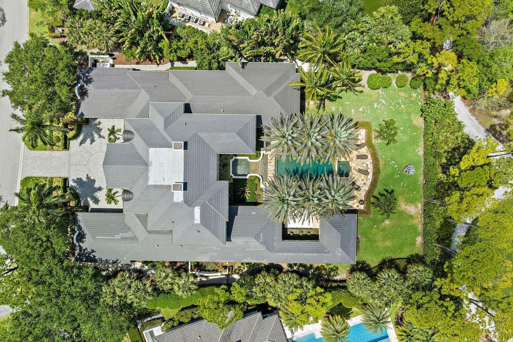 Welcome to 107 W Bears Club Dr, an exquisite custom-built estate in the exclusive Bears Club community in Jupiter, Florida.