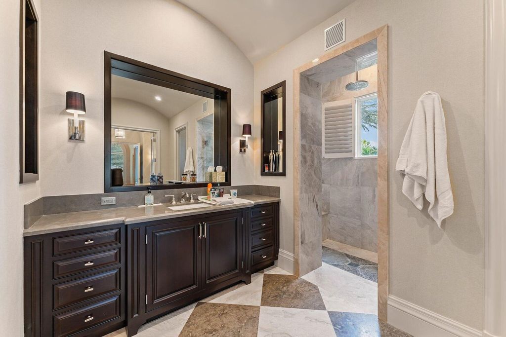 Welcome to 107 W Bears Club Dr, an exquisite custom-built estate in the exclusive Bears Club community in Jupiter, Florida.
