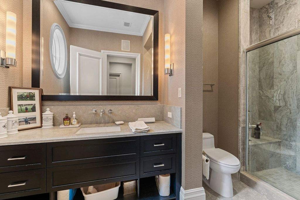 Welcome to 107 W Bears Club Dr, an exquisite custom-built estate in the exclusive Bears Club community in Jupiter, Florida.