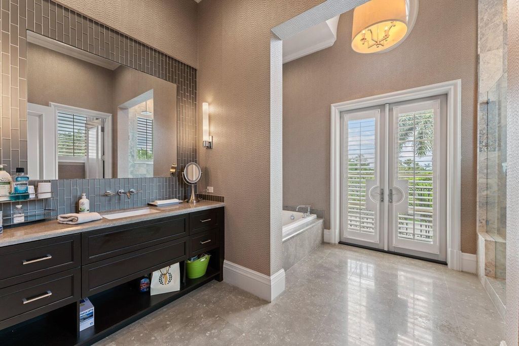 Welcome to 107 W Bears Club Dr, an exquisite custom-built estate in the exclusive Bears Club community in Jupiter, Florida.