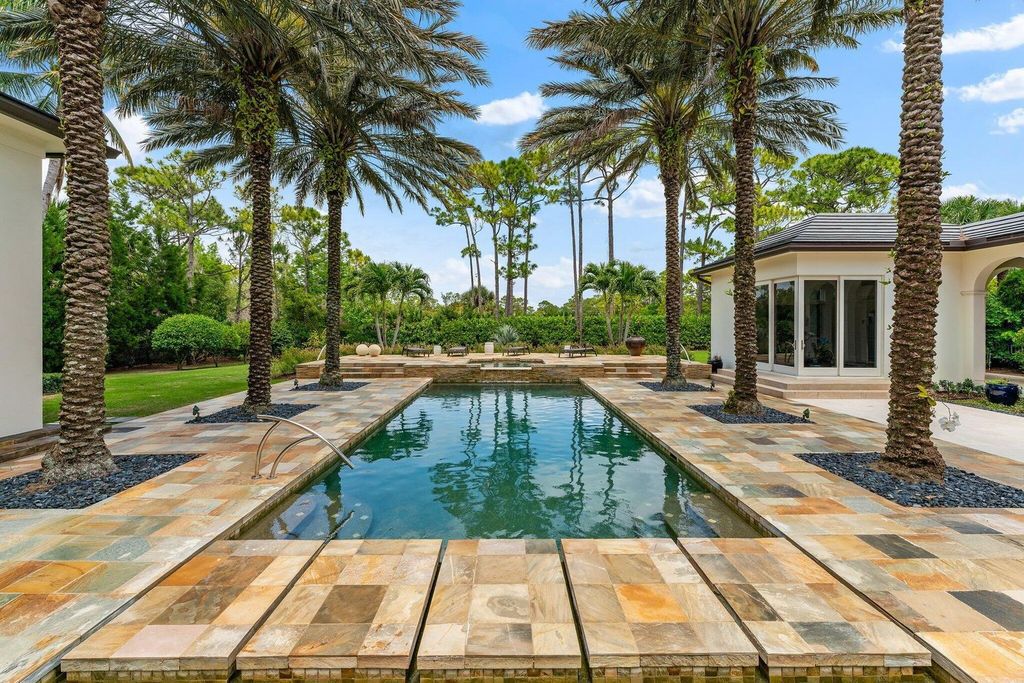 Welcome to 107 W Bears Club Dr, an exquisite custom-built estate in the exclusive Bears Club community in Jupiter, Florida.