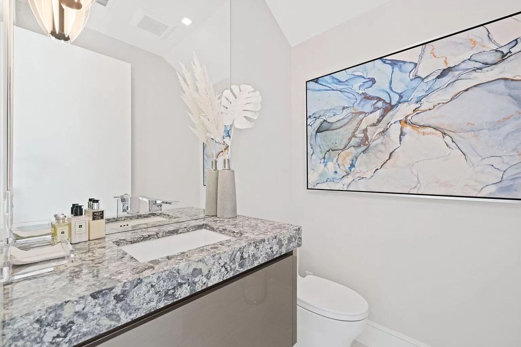 This 5-bed, 7-bath masterpiece, built in 2021, spans over 6,159 sq ft on a 0.30-acre lot. Highlights include a 2-story great room with stunning glass walls and a gas fireplace, a formal dining room with a glass wine closet, a custom kitchen with double-thick quartzite countertops, Miele appliances, and Carrara porcelain tiles.