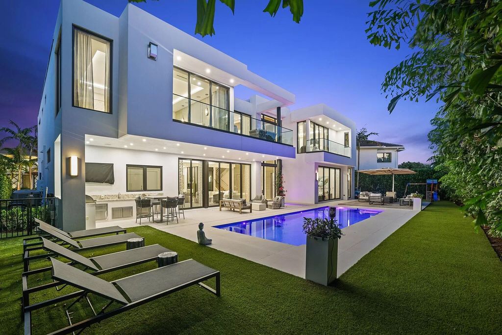 This 5-bed, 7-bath masterpiece, built in 2021, spans over 6,159 sq ft on a 0.30-acre lot. Highlights include a 2-story great room with stunning glass walls and a gas fireplace, a formal dining room with a glass wine closet, a custom kitchen with double-thick quartzite countertops, Miele appliances, and Carrara porcelain tiles.