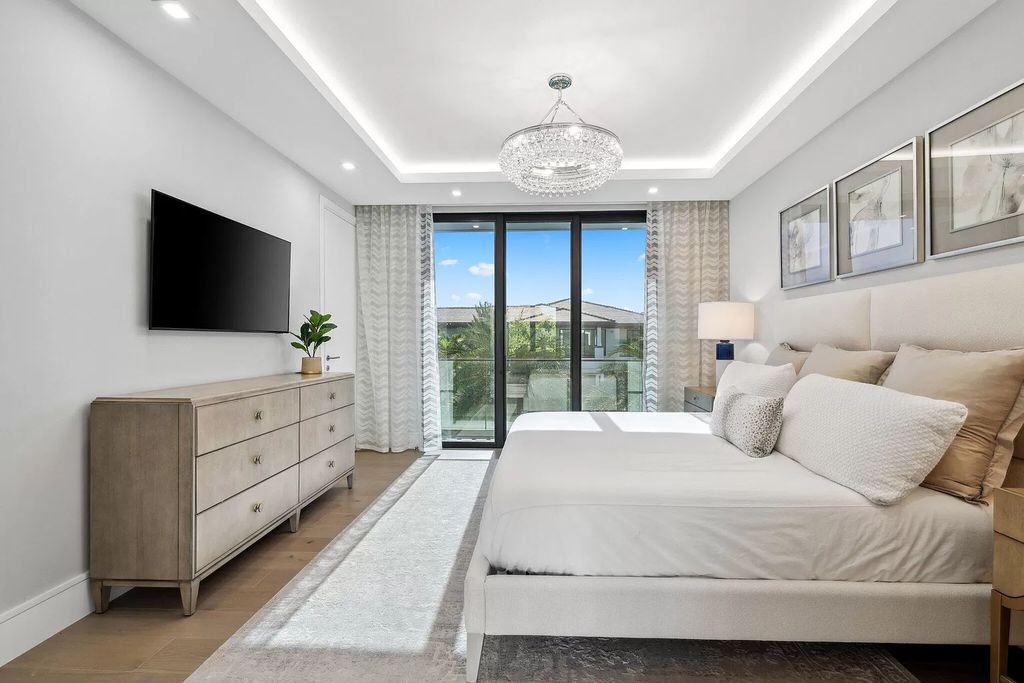 This 5-bed, 7-bath masterpiece, built in 2021, spans over 6,159 sq ft on a 0.30-acre lot. Highlights include a 2-story great room with stunning glass walls and a gas fireplace, a formal dining room with a glass wine closet, a custom kitchen with double-thick quartzite countertops, Miele appliances, and Carrara porcelain tiles.