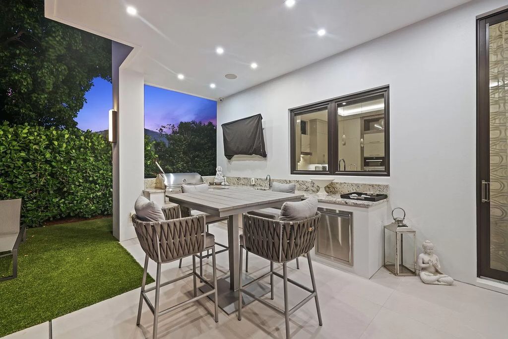This 5-bed, 7-bath masterpiece, built in 2021, spans over 6,159 sq ft on a 0.30-acre lot. Highlights include a 2-story great room with stunning glass walls and a gas fireplace, a formal dining room with a glass wine closet, a custom kitchen with double-thick quartzite countertops, Miele appliances, and Carrara porcelain tiles.