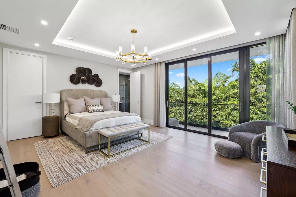 This 5-bed, 7-bath masterpiece, built in 2021, spans over 6,159 sq ft on a 0.30-acre lot. Highlights include a 2-story great room with stunning glass walls and a gas fireplace, a formal dining room with a glass wine closet, a custom kitchen with double-thick quartzite countertops, Miele appliances, and Carrara porcelain tiles.