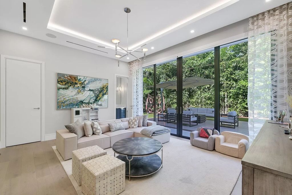 This 5-bed, 7-bath masterpiece, built in 2021, spans over 6,159 sq ft on a 0.30-acre lot. Highlights include a 2-story great room with stunning glass walls and a gas fireplace, a formal dining room with a glass wine closet, a custom kitchen with double-thick quartzite countertops, Miele appliances, and Carrara porcelain tiles.