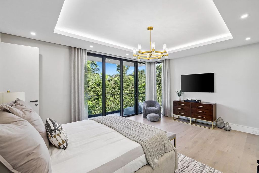 This 5-bed, 7-bath masterpiece, built in 2021, spans over 6,159 sq ft on a 0.30-acre lot. Highlights include a 2-story great room with stunning glass walls and a gas fireplace, a formal dining room with a glass wine closet, a custom kitchen with double-thick quartzite countertops, Miele appliances, and Carrara porcelain tiles.