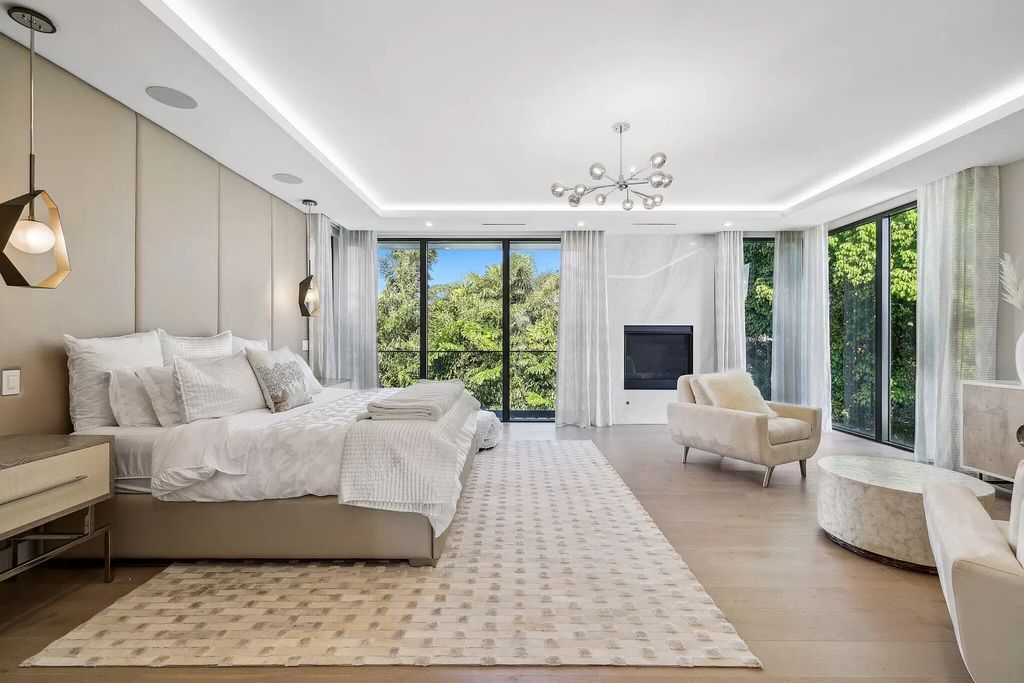 This 5-bed, 7-bath masterpiece, built in 2021, spans over 6,159 sq ft on a 0.30-acre lot. Highlights include a 2-story great room with stunning glass walls and a gas fireplace, a formal dining room with a glass wine closet, a custom kitchen with double-thick quartzite countertops, Miele appliances, and Carrara porcelain tiles.