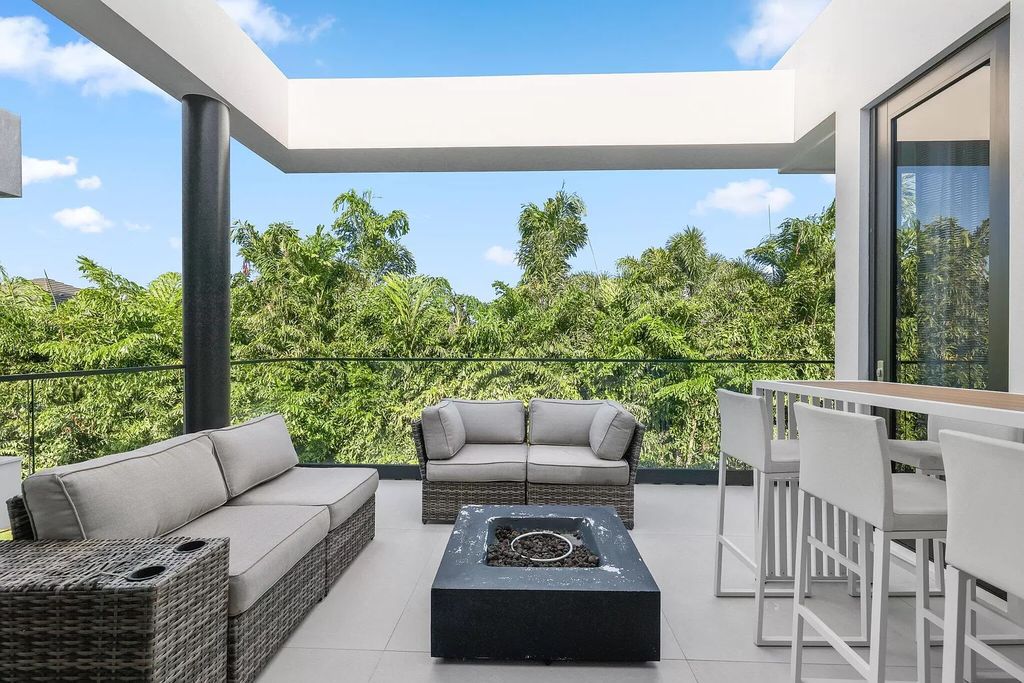 This 5-bed, 7-bath masterpiece, built in 2021, spans over 6,159 sq ft on a 0.30-acre lot. Highlights include a 2-story great room with stunning glass walls and a gas fireplace, a formal dining room with a glass wine closet, a custom kitchen with double-thick quartzite countertops, Miele appliances, and Carrara porcelain tiles.