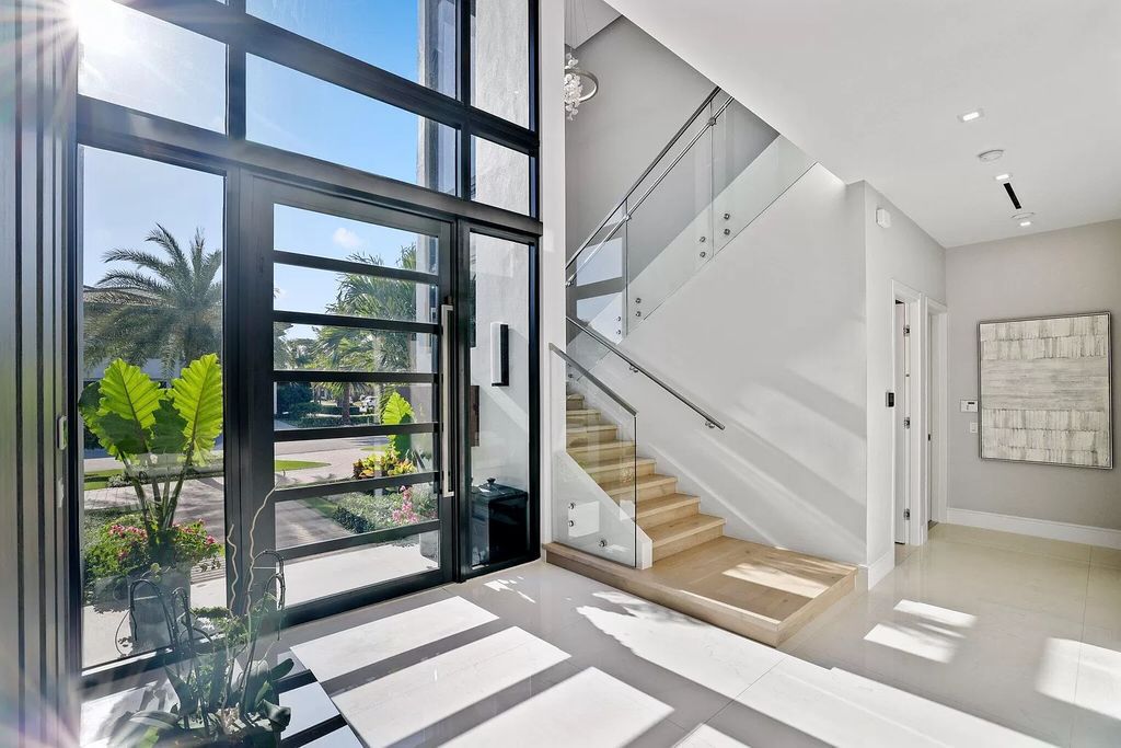 This 5-bed, 7-bath masterpiece, built in 2021, spans over 6,159 sq ft on a 0.30-acre lot. Highlights include a 2-story great room with stunning glass walls and a gas fireplace, a formal dining room with a glass wine closet, a custom kitchen with double-thick quartzite countertops, Miele appliances, and Carrara porcelain tiles.