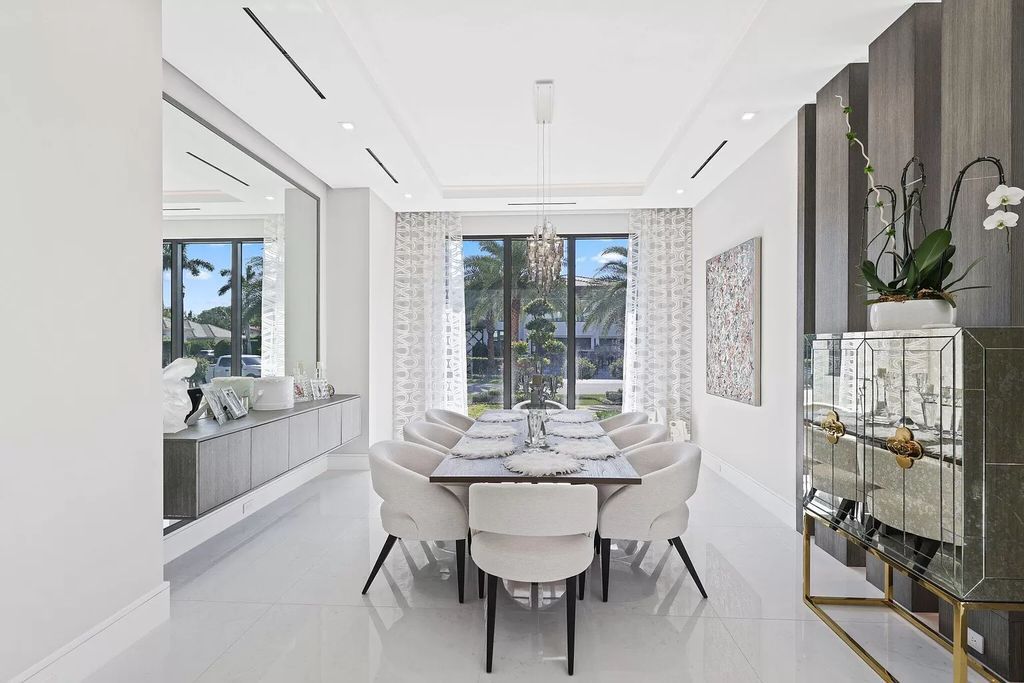 This 5-bed, 7-bath masterpiece, built in 2021, spans over 6,159 sq ft on a 0.30-acre lot. Highlights include a 2-story great room with stunning glass walls and a gas fireplace, a formal dining room with a glass wine closet, a custom kitchen with double-thick quartzite countertops, Miele appliances, and Carrara porcelain tiles.