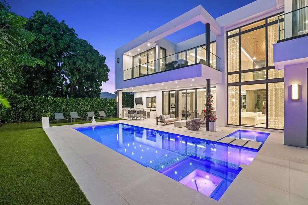 This 5-bed, 7-bath masterpiece, built in 2021, spans over 6,159 sq ft on a 0.30-acre lot. Highlights include a 2-story great room with stunning glass walls and a gas fireplace, a formal dining room with a glass wine closet, a custom kitchen with double-thick quartzite countertops, Miele appliances, and Carrara porcelain tiles.