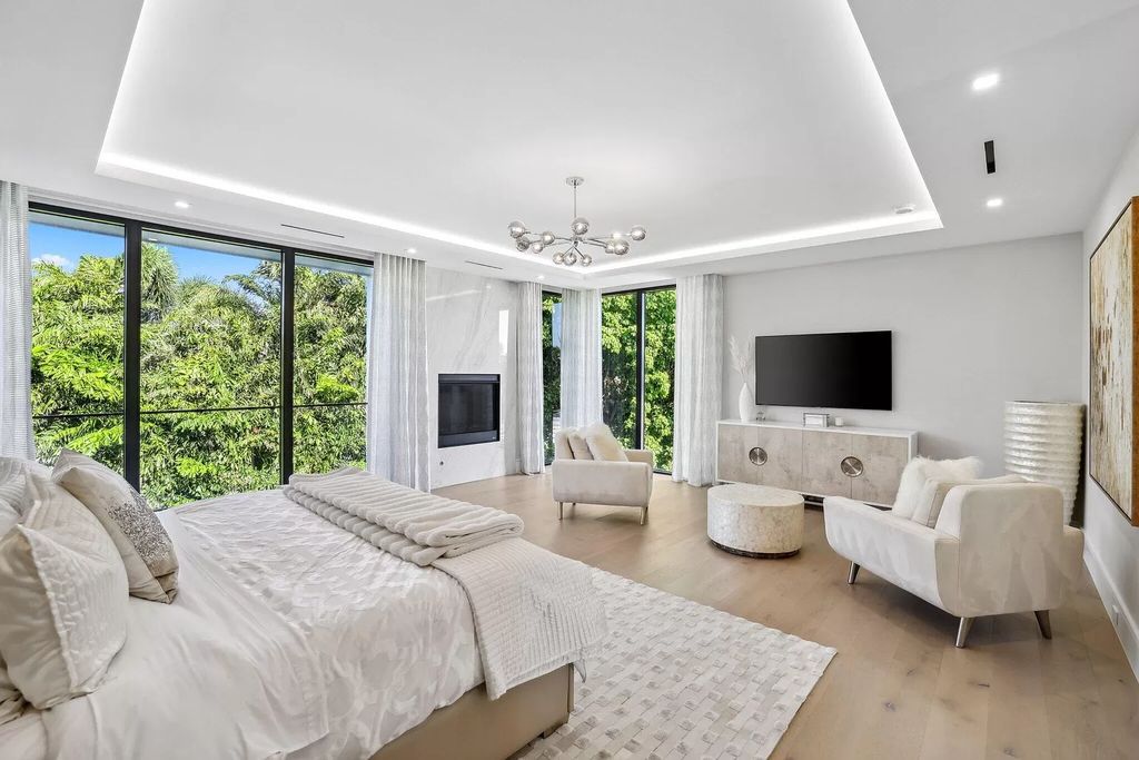 This 5-bed, 7-bath masterpiece, built in 2021, spans over 6,159 sq ft on a 0.30-acre lot. Highlights include a 2-story great room with stunning glass walls and a gas fireplace, a formal dining room with a glass wine closet, a custom kitchen with double-thick quartzite countertops, Miele appliances, and Carrara porcelain tiles.