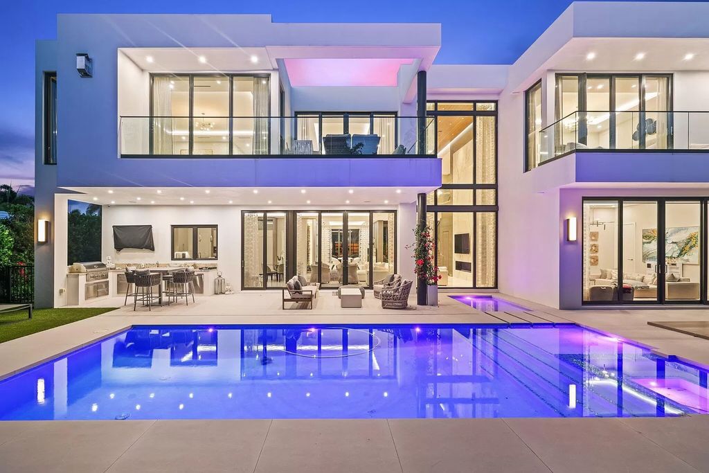 This 5-bed, 7-bath masterpiece, built in 2021, spans over 6,159 sq ft on a 0.30-acre lot. Highlights include a 2-story great room with stunning glass walls and a gas fireplace, a formal dining room with a glass wine closet, a custom kitchen with double-thick quartzite countertops, Miele appliances, and Carrara porcelain tiles.