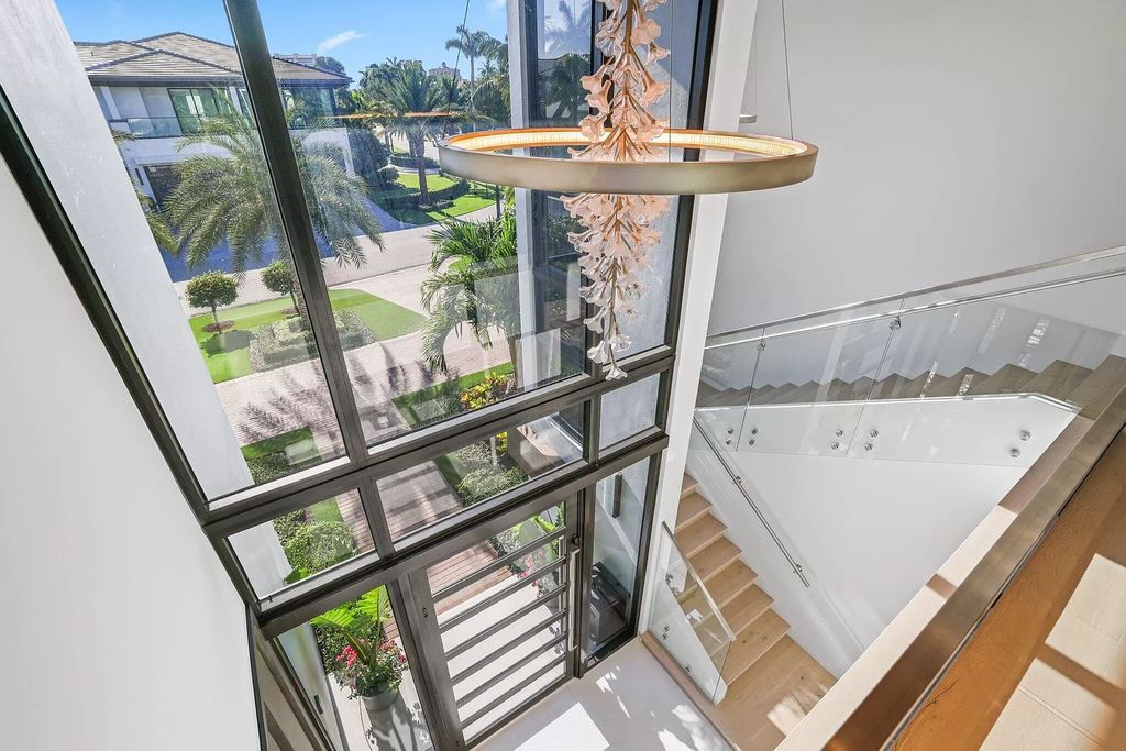 This 5-bed, 7-bath masterpiece, built in 2021, spans over 6,159 sq ft on a 0.30-acre lot. Highlights include a 2-story great room with stunning glass walls and a gas fireplace, a formal dining room with a glass wine closet, a custom kitchen with double-thick quartzite countertops, Miele appliances, and Carrara porcelain tiles.