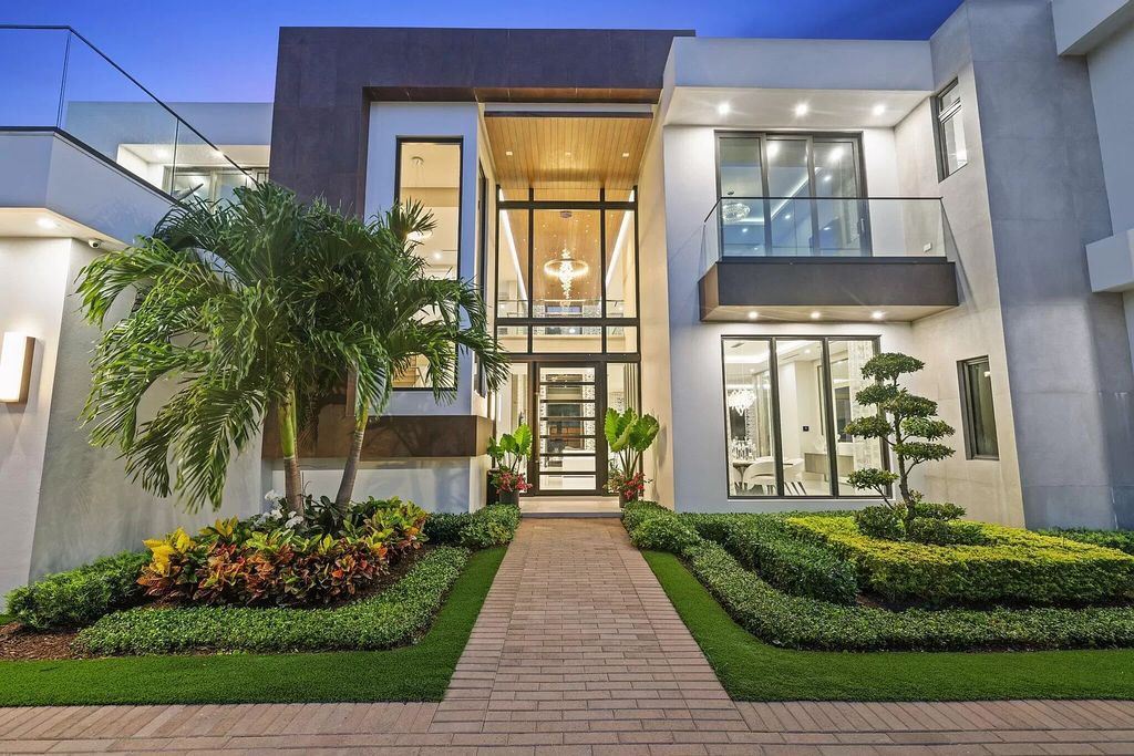 This 5-bed, 7-bath masterpiece, built in 2021, spans over 6,159 sq ft on a 0.30-acre lot. Highlights include a 2-story great room with stunning glass walls and a gas fireplace, a formal dining room with a glass wine closet, a custom kitchen with double-thick quartzite countertops, Miele appliances, and Carrara porcelain tiles.