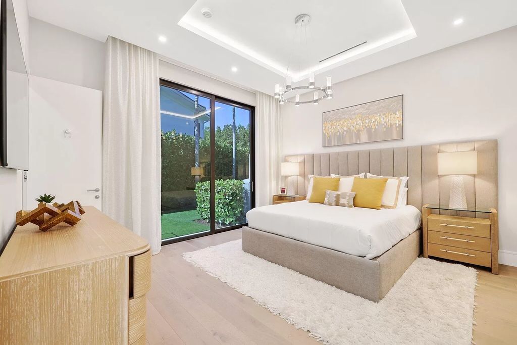 This 5-bed, 7-bath masterpiece, built in 2021, spans over 6,159 sq ft on a 0.30-acre lot. Highlights include a 2-story great room with stunning glass walls and a gas fireplace, a formal dining room with a glass wine closet, a custom kitchen with double-thick quartzite countertops, Miele appliances, and Carrara porcelain tiles.