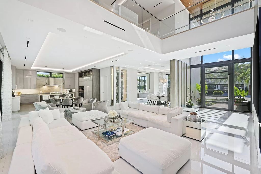 This 5-bed, 7-bath masterpiece, built in 2021, spans over 6,159 sq ft on a 0.30-acre lot. Highlights include a 2-story great room with stunning glass walls and a gas fireplace, a formal dining room with a glass wine closet, a custom kitchen with double-thick quartzite countertops, Miele appliances, and Carrara porcelain tiles.