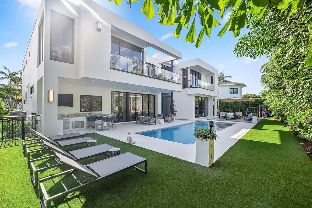 This 5-bed, 7-bath masterpiece, built in 2021, spans over 6,159 sq ft on a 0.30-acre lot. Highlights include a 2-story great room with stunning glass walls and a gas fireplace, a formal dining room with a glass wine closet, a custom kitchen with double-thick quartzite countertops, Miele appliances, and Carrara porcelain tiles.