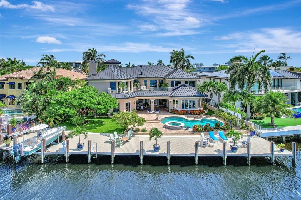 A boater's dream, the estate sits on a 12,651 square feet lot with a 2,000 square feet dock and boat lift. The 6,788 square feet home features generous living areas, an elevator, and an expansive second-floor terrace with an oversized primary bedroom, loft, and office den.