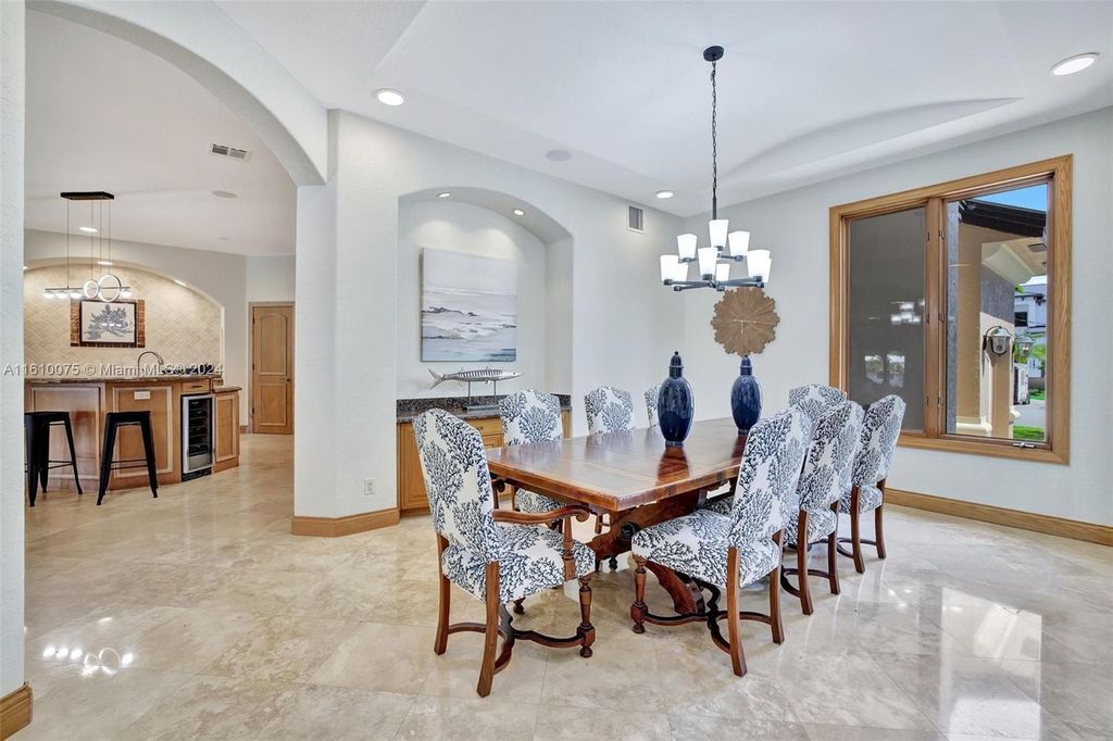 A boater's dream, the estate sits on a 12,651 square feet lot with a 2,000 square feet dock and boat lift. The 6,788 square feet home features generous living areas, an elevator, and an expansive second-floor terrace with an oversized primary bedroom, loft, and office den.