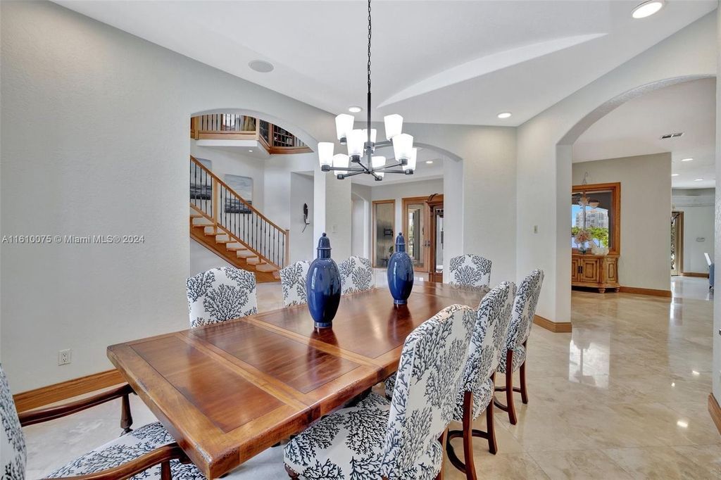 A boater's dream, the estate sits on a 12,651 square feet lot with a 2,000 square feet dock and boat lift. The 6,788 square feet home features generous living areas, an elevator, and an expansive second-floor terrace with an oversized primary bedroom, loft, and office den.