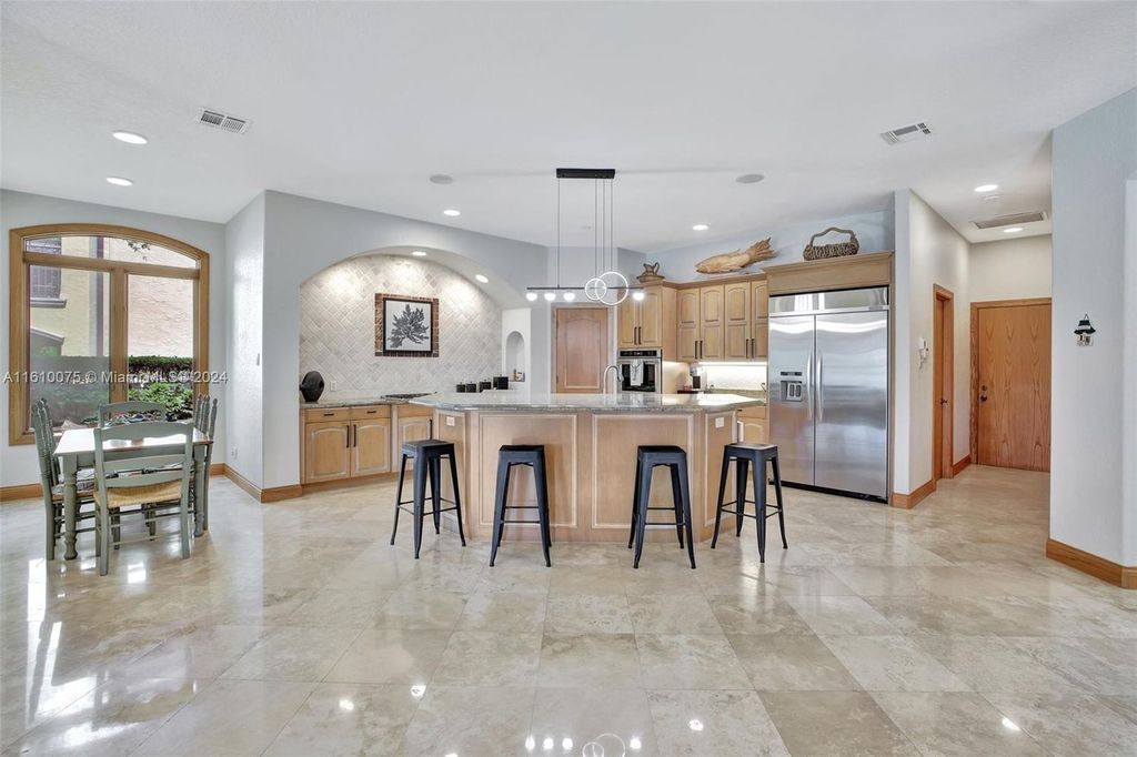 A boater's dream, the estate sits on a 12,651 square feet lot with a 2,000 square feet dock and boat lift. The 6,788 square feet home features generous living areas, an elevator, and an expansive second-floor terrace with an oversized primary bedroom, loft, and office den.