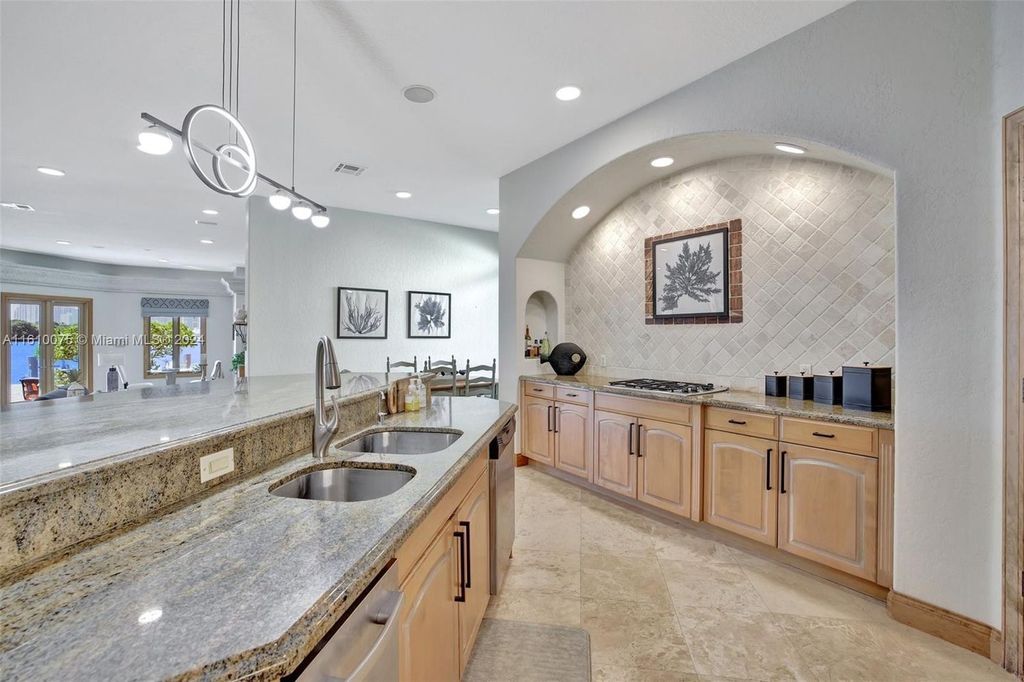A boater's dream, the estate sits on a 12,651 square feet lot with a 2,000 square feet dock and boat lift. The 6,788 square feet home features generous living areas, an elevator, and an expansive second-floor terrace with an oversized primary bedroom, loft, and office den.