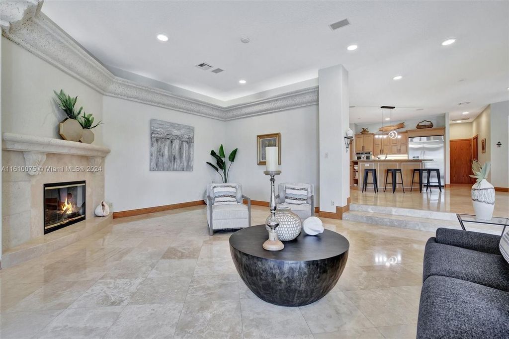 A boater's dream, the estate sits on a 12,651 square feet lot with a 2,000 square feet dock and boat lift. The 6,788 square feet home features generous living areas, an elevator, and an expansive second-floor terrace with an oversized primary bedroom, loft, and office den.