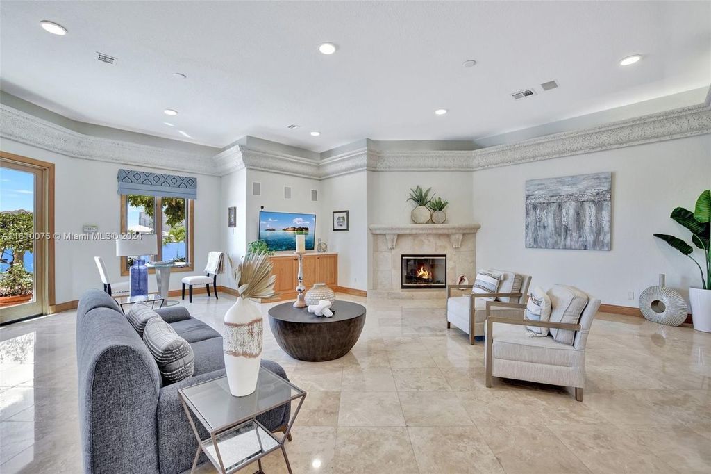 A boater's dream, the estate sits on a 12,651 square feet lot with a 2,000 square feet dock and boat lift. The 6,788 square feet home features generous living areas, an elevator, and an expansive second-floor terrace with an oversized primary bedroom, loft, and office den.