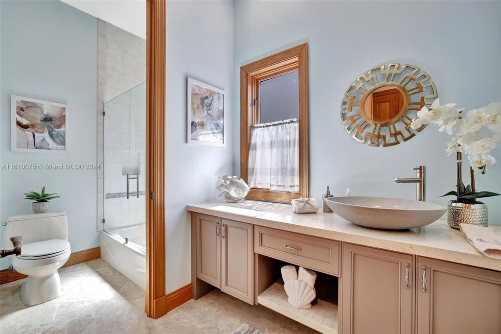 A boater's dream, the estate sits on a 12,651 square feet lot with a 2,000 square feet dock and boat lift. The 6,788 square feet home features generous living areas, an elevator, and an expansive second-floor terrace with an oversized primary bedroom, loft, and office den.