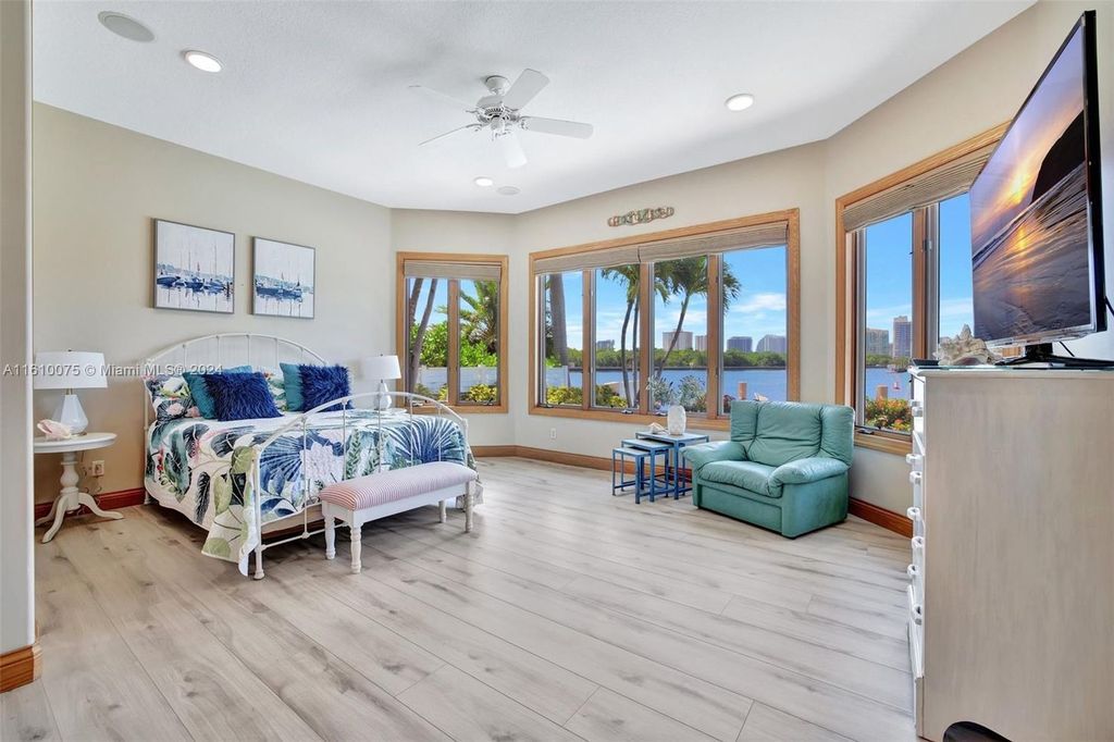 A boater's dream, the estate sits on a 12,651 square feet lot with a 2,000 square feet dock and boat lift. The 6,788 square feet home features generous living areas, an elevator, and an expansive second-floor terrace with an oversized primary bedroom, loft, and office den.