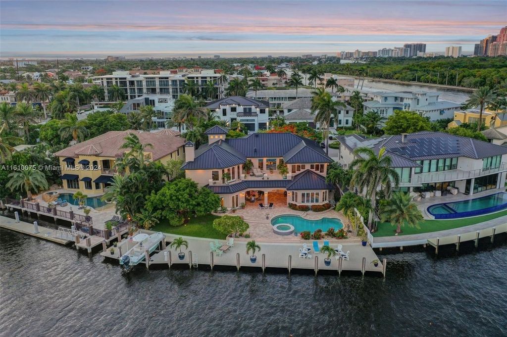 A boater's dream, the estate sits on a 12,651 square feet lot with a 2,000 square feet dock and boat lift. The 6,788 square feet home features generous living areas, an elevator, and an expansive second-floor terrace with an oversized primary bedroom, loft, and office den.