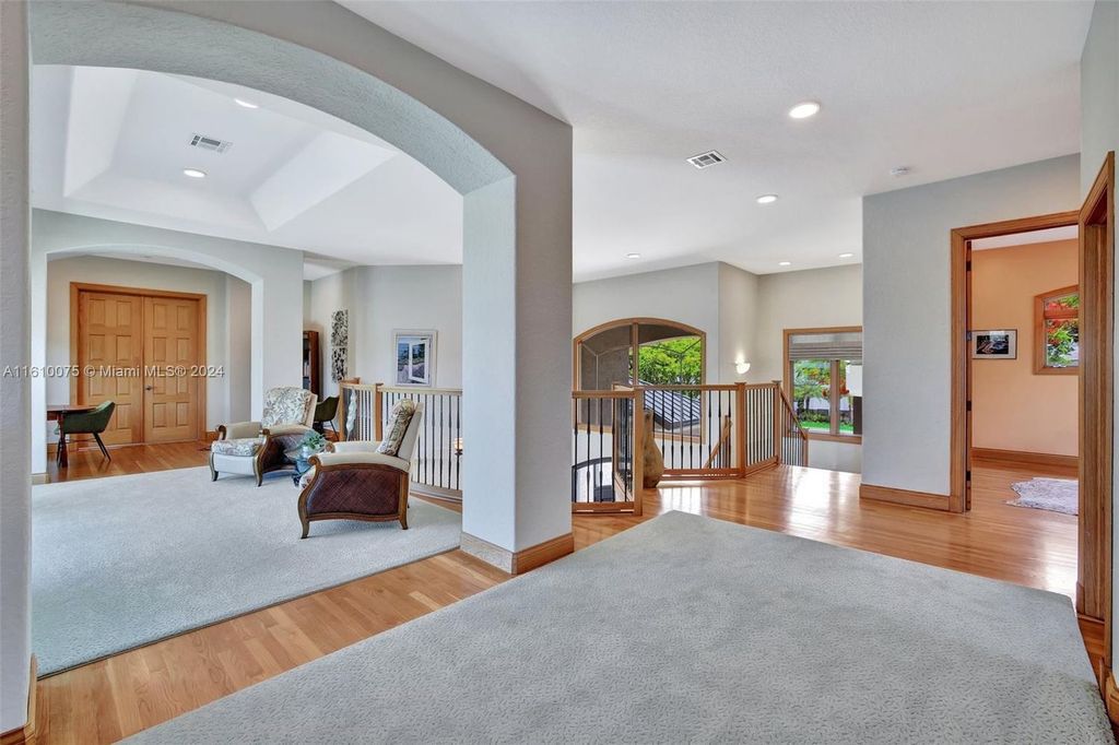 A boater's dream, the estate sits on a 12,651 square feet lot with a 2,000 square feet dock and boat lift. The 6,788 square feet home features generous living areas, an elevator, and an expansive second-floor terrace with an oversized primary bedroom, loft, and office den.