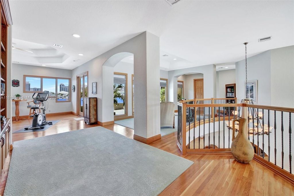 A boater's dream, the estate sits on a 12,651 square feet lot with a 2,000 square feet dock and boat lift. The 6,788 square feet home features generous living areas, an elevator, and an expansive second-floor terrace with an oversized primary bedroom, loft, and office den.