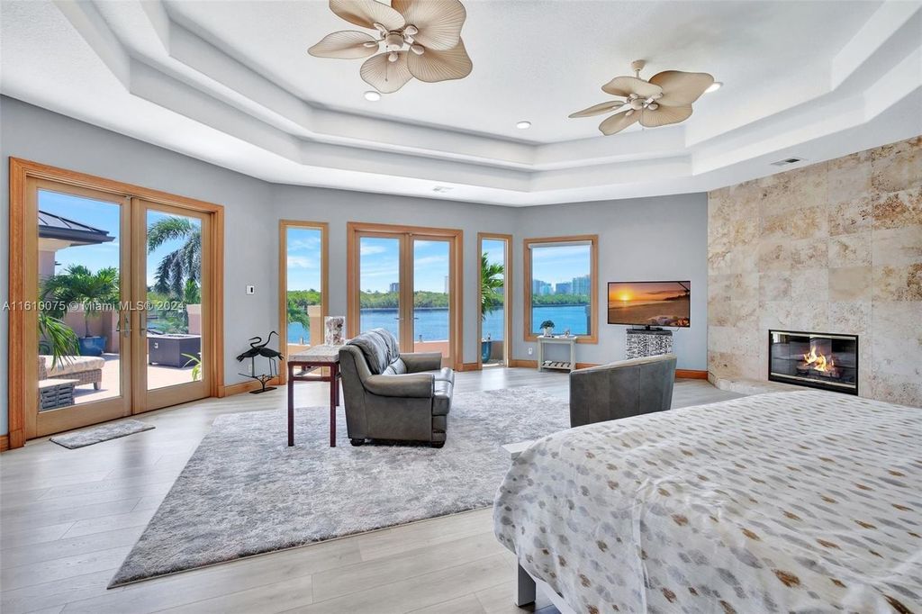 A boater's dream, the estate sits on a 12,651 square feet lot with a 2,000 square feet dock and boat lift. The 6,788 square feet home features generous living areas, an elevator, and an expansive second-floor terrace with an oversized primary bedroom, loft, and office den.