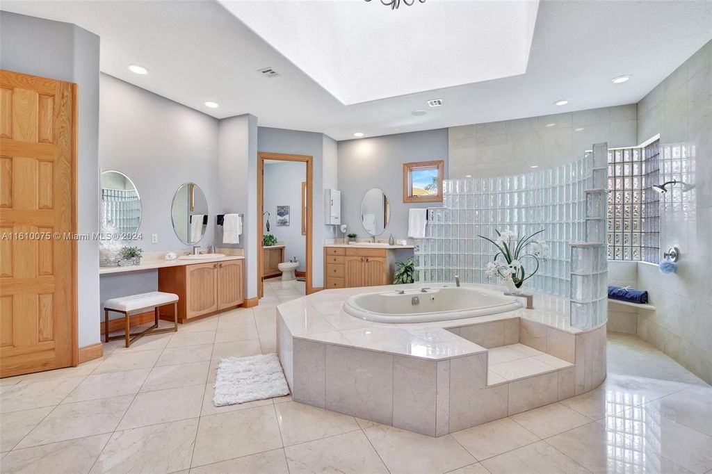 A boater's dream, the estate sits on a 12,651 square feet lot with a 2,000 square feet dock and boat lift. The 6,788 square feet home features generous living areas, an elevator, and an expansive second-floor terrace with an oversized primary bedroom, loft, and office den.