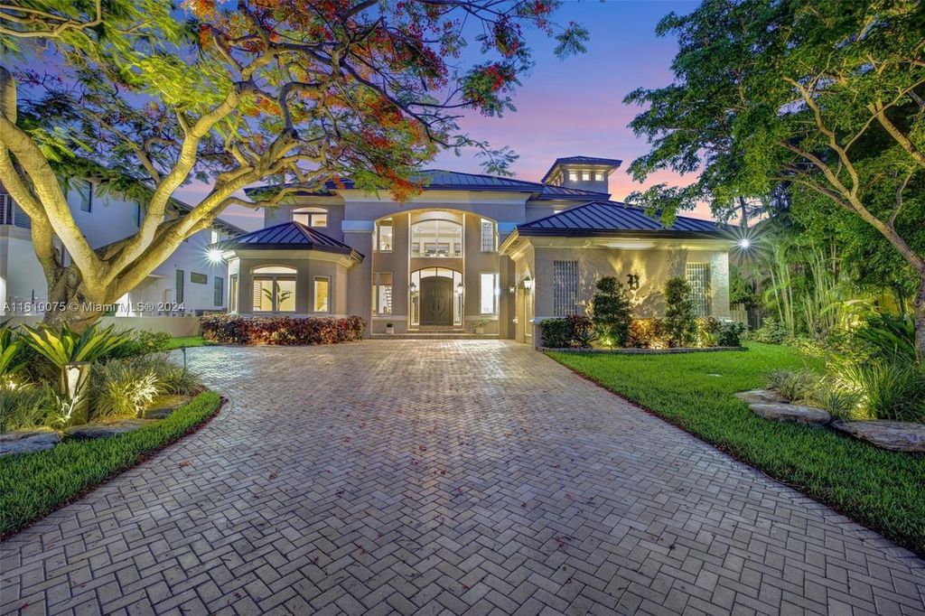A boater's dream, the estate sits on a 12,651 square feet lot with a 2,000 square feet dock and boat lift. The 6,788 square feet home features generous living areas, an elevator, and an expansive second-floor terrace with an oversized primary bedroom, loft, and office den.