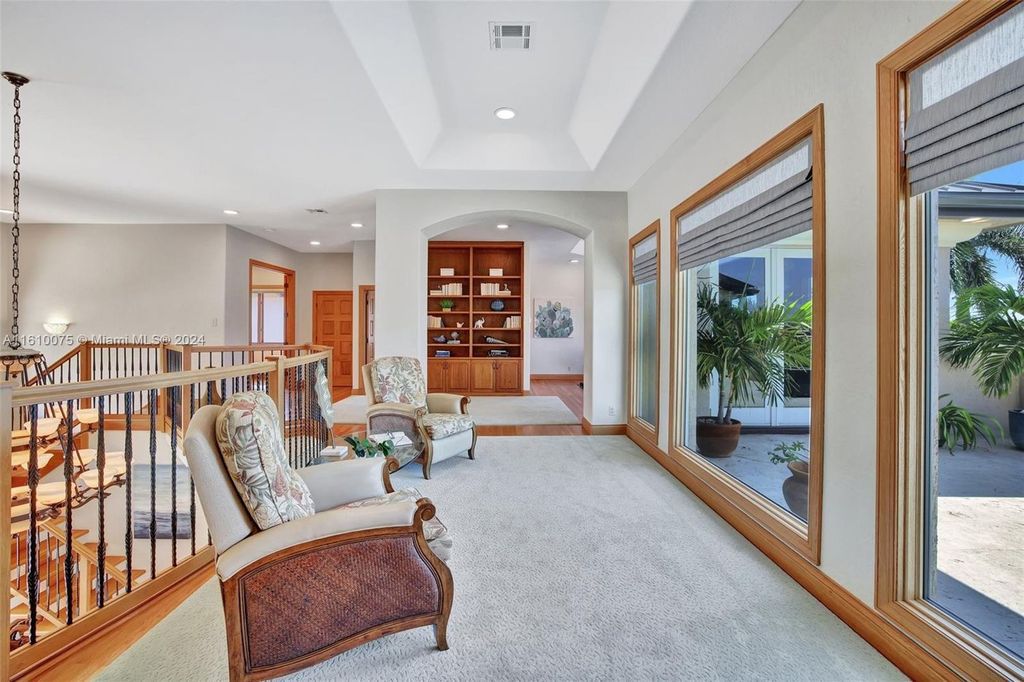 A boater's dream, the estate sits on a 12,651 square feet lot with a 2,000 square feet dock and boat lift. The 6,788 square feet home features generous living areas, an elevator, and an expansive second-floor terrace with an oversized primary bedroom, loft, and office den.