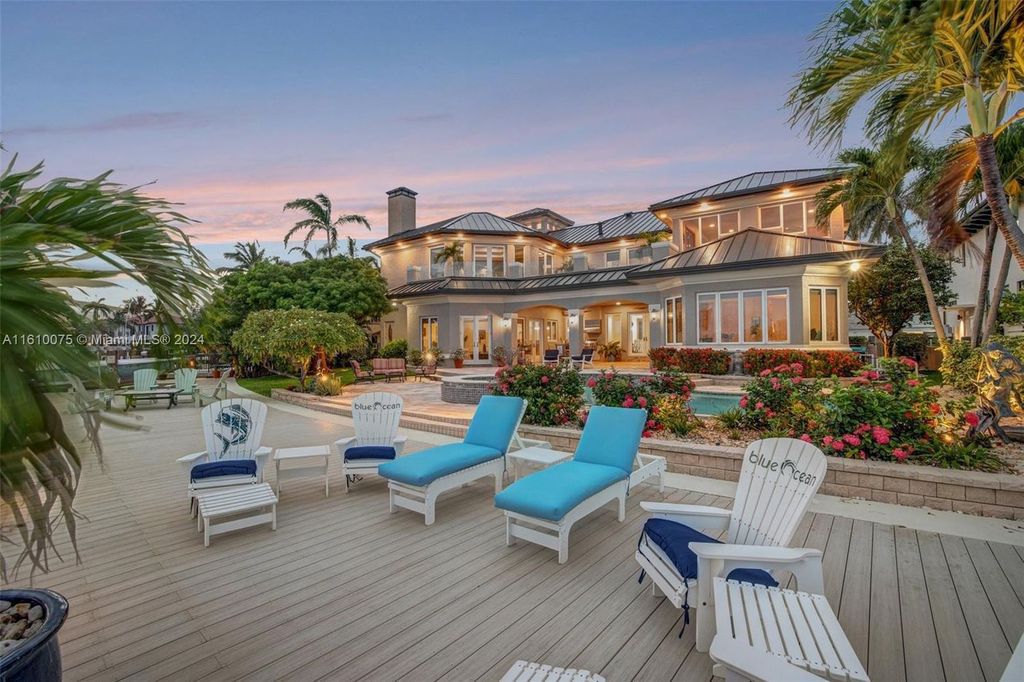 A boater's dream, the estate sits on a 12,651 square feet lot with a 2,000 square feet dock and boat lift. The 6,788 square feet home features generous living areas, an elevator, and an expansive second-floor terrace with an oversized primary bedroom, loft, and office den.