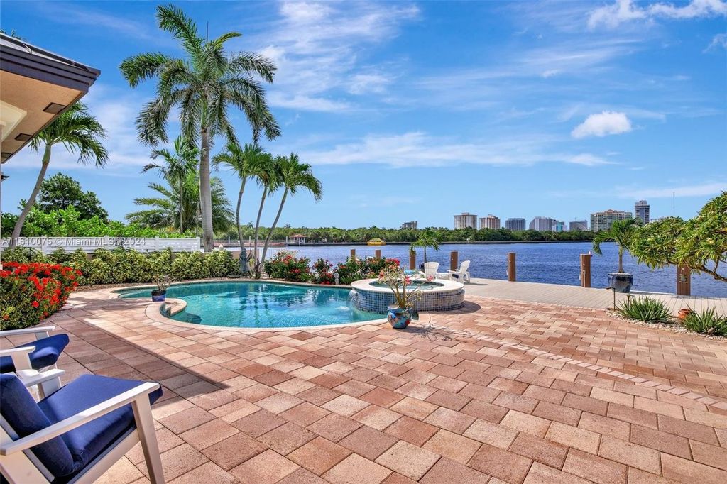 A boater's dream, the estate sits on a 12,651 square feet lot with a 2,000 square feet dock and boat lift. The 6,788 square feet home features generous living areas, an elevator, and an expansive second-floor terrace with an oversized primary bedroom, loft, and office den.