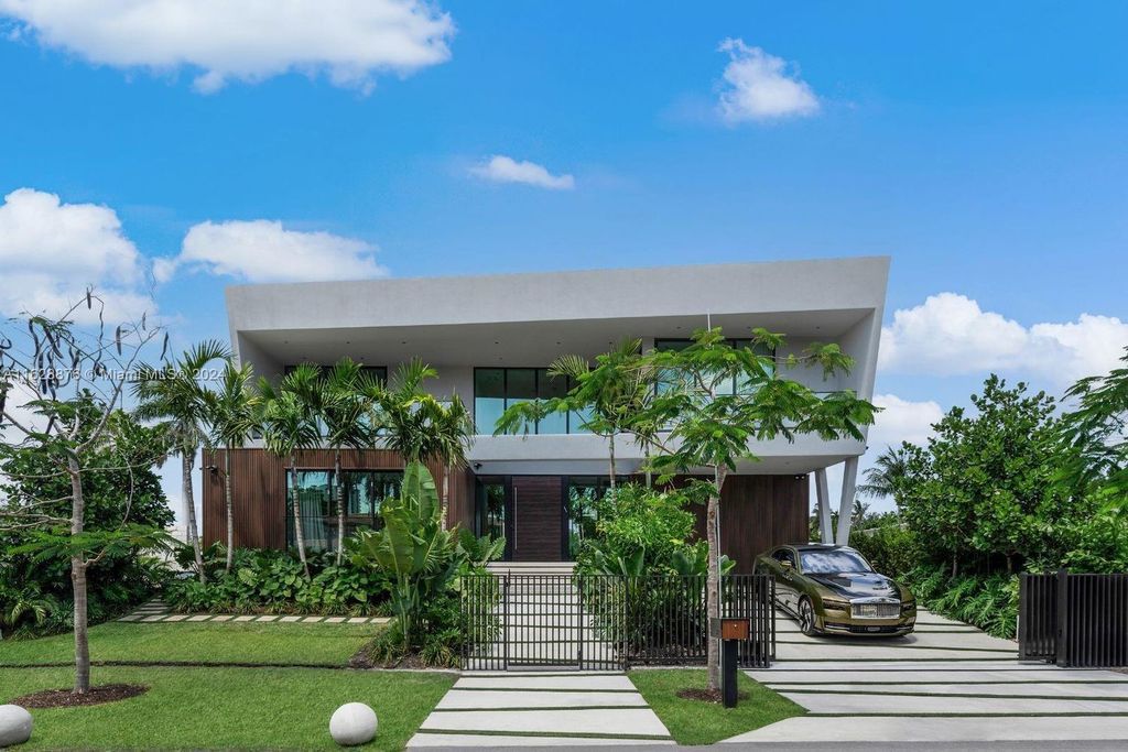 Discover an extraordinary waterfront compound in gated San Souci Estates, featuring a brand new ultra-modern home and a sophisticated guest house on a double lot.