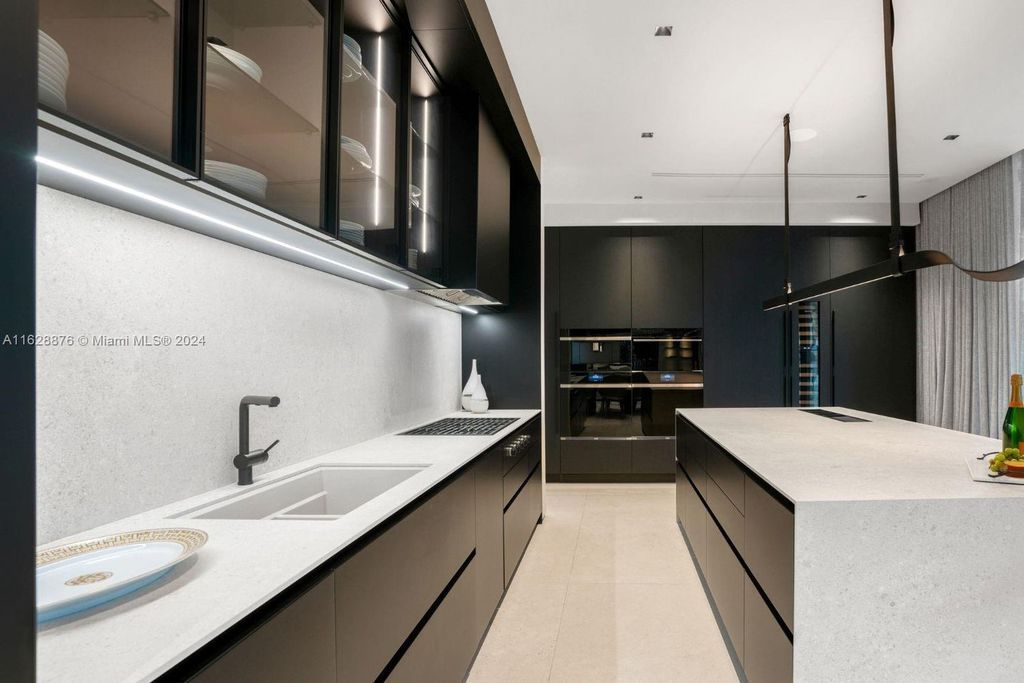 Discover an extraordinary waterfront compound in gated San Souci Estates, featuring a brand new ultra-modern home and a sophisticated guest house on a double lot.