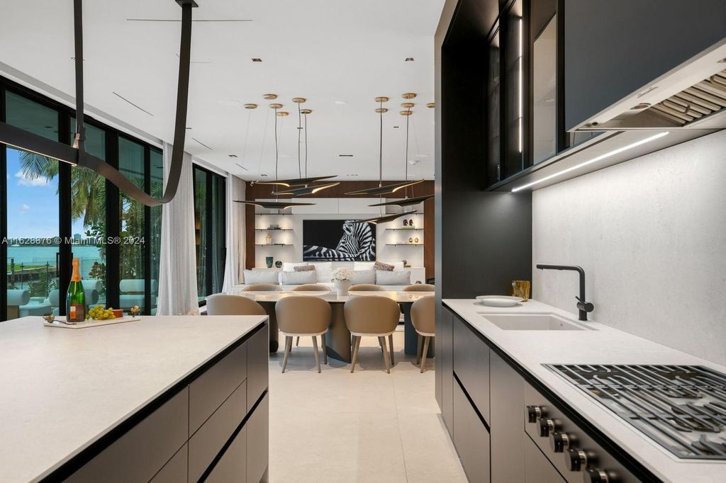 Discover an extraordinary waterfront compound in gated San Souci Estates, featuring a brand new ultra-modern home and a sophisticated guest house on a double lot.